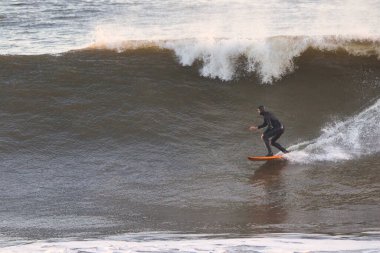 Surfing Giant waves on West Beach in Santa Barbara