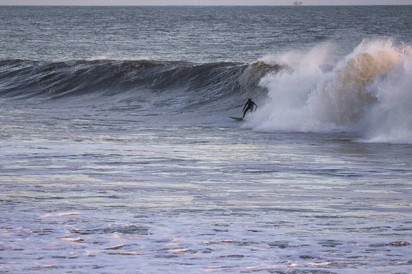 Surfing Giant waves on West Beach in Santa Barbara