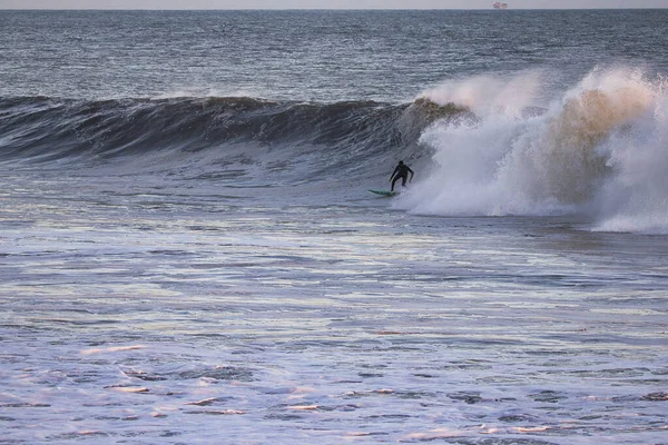 Surfing Giant waves on West Beach in Santa Barbara