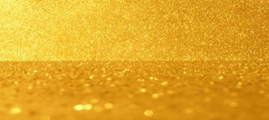 Altın parıltısı Noel arkaplanı. Düğün, doğum günü, ödül töreni gibi şenlikli etkinlikler için ışıl ışıl bir ortam. Zarif lüks altın bayrak. Parlak birinci sınıf fon. Sarı ışıltılı bg