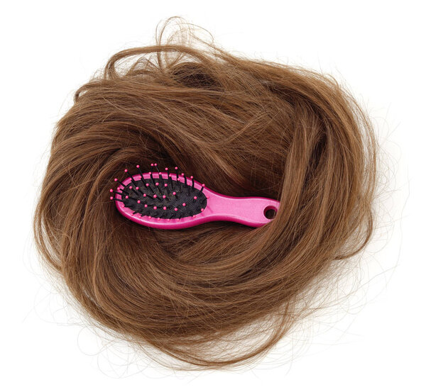 Bunch of artificial hair and hairbrush isolated on white background.