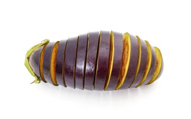 One sliced eggplant with basil leaves isolated on a white background.