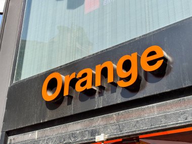Alicante, İspanya - 24 Haziran 2025: Orange marka logo mağaza vitrininde sergilenmektedir, koyu rengi ve çağdaş stili, görünürlüğü ve cazibesini artırmaktadır