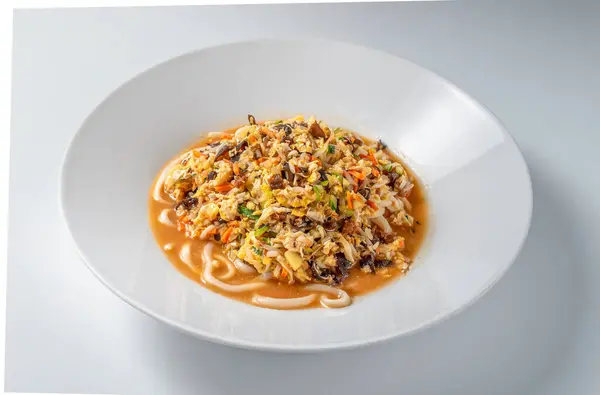 Beyaz arka planda servis edilen Çin yapımı soya soslu ve yumurtalı mian eriştesi yasağı. Temiz, az estetik ve canlı aromalı lezzetli, geleneksel bir Asya yemeği.