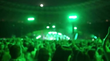 Seyirci konseri izliyor, elleri havada dans ediyor ve şarkı söylüyor, zıplıyor. Sahne ışıkları. Konserdeki mutlu insanlar. Müzik konsepti. Canlı yayın. Yüksek kalite 4k görüntü