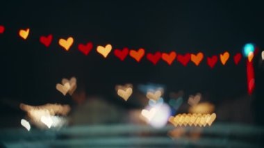 Bright twinkling lights in the shape of a heart on a black screen.Bokeh background.Beautiful light abstract bokeh effect.Magic romantic abstract background.Valentines Day.High quality 4k footage