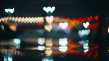 Bright twinkling lights in the shape of a heart on a black screen.Bokeh background.Beautiful light abstract bokeh effect.Magic romantic abstract background.Valentines Day.High quality 4k footage
