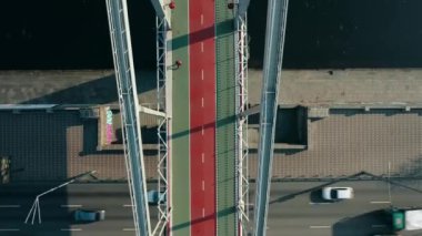 UKRAINE, Kyiv, - JULY 16, 2020: Aerial view of the Park Pedestrian Bridge in Kyiv. Ukraine. Pedestrian bridge over the roadway and the river. Drone video footage. High-quality shooting in 4k format