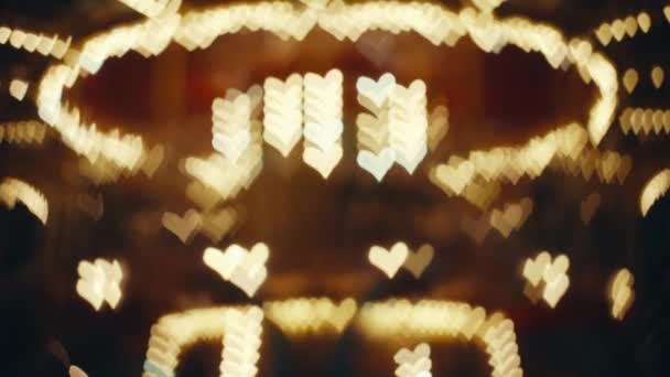 Defocused Heart Shaped Carousel Lights Abstract Bokeh Effect Golden Hearts — Stock video