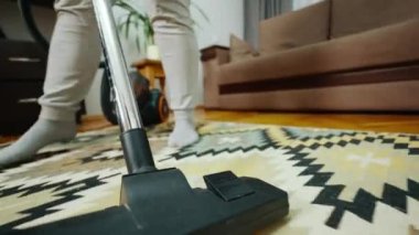 Elektrikli süpürgeyle odayı temizliyorum. Hortumu kapatıyoruz. Elektrikli süpürge tüylü halıyı temizler. Bakış açısı atışı. Elektrik süpürgesine kamera monte edilmiş. Yüksek kalite 4k görüntü