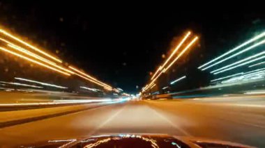 Gece yarısı araba sürme hiperlaboratuarları. Arabanın içinden görüntüyü al. Gece yolu. Şoför, gece şehrinden geçiyor. Arabadan manzarası var. Yüksek kalite 4k görüntü