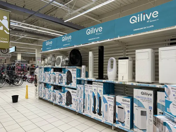 Varşova, Polonya - 22 Mayıs 2025: Qilive marka cihazlar canlı bir alışveriş atmosferinde perakende satış mağazasında perakendeciler ve klimaların yer aldığı raflarda düzgün bir şekilde düzenlenmiştir.