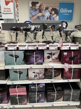 Varşova, Polonya - 22 Mayıs 2025: Remington ve Qilive gibi markaların saç kurutma makineleriyle dolu perakende rafı, saç bakım meraklıları için çeşitli seçenekler sunuyor