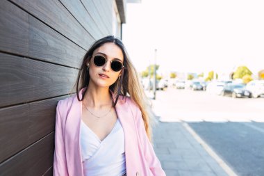 Alışveriş merkezinin dışında duran kendinden emin ve güçlü genç bir kadın. Yüksek kalite fotoğraf