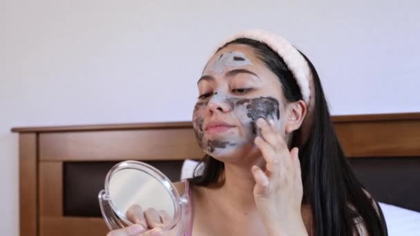 Young Woman Her Bed Applying Moisturizing Facial Sheet Mask Skin — Stock Video
