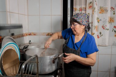 Şili usulü börek pişirmek için soğan ve et doğrayan Latin kadına yaklaş.. 