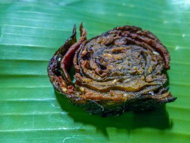 Indian Alu Vadi (Patra Recipe) is placed on banana leaves  clipart