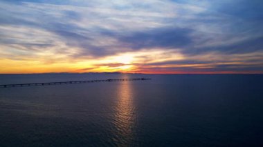 Gün batımında deniz üzerindeki bir gaz boru hattının havadan görüntüsü.