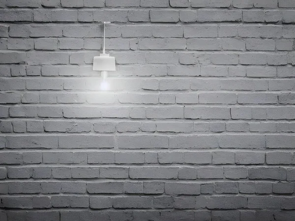 a brick wall with a lamp on top of it