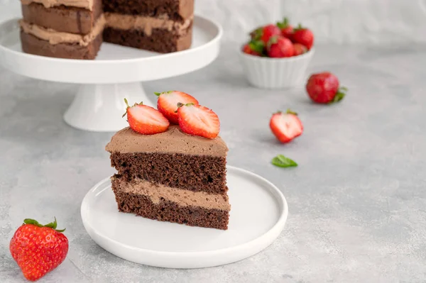 stock image Naked chocolate cake with cream and fresh strawberries on top. Rustic style. Selective focus. Copy space