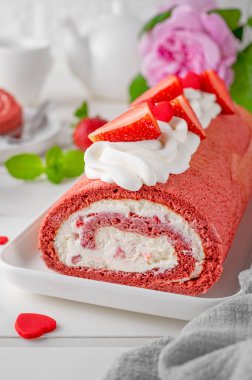 Red velvet rolled cake with fresh strawberries and cream cheese. Valentine's Day dessert. Selective focus