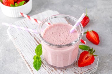Çilekli milkshake ya da cam kavanozdaki gri beton arka planda smoothie kokteyli. Boşluğu kopyala