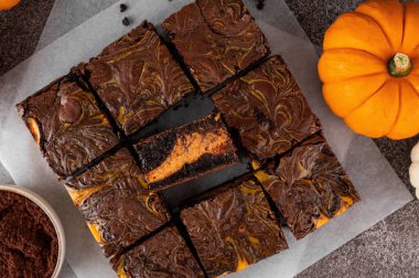 Baharatlı balkabaklı cheesecake ile çikolatalı brownie. Cadılar Bayramı veya Şükran Günü tatlısı. Boşluğu kopyala