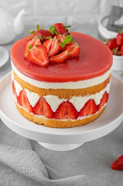 Fraisier mousse cake. Strawberry cake with sponge cake, mousse and jelly on a gray concrete background. Summer dessert. Selective focus. Copy space.