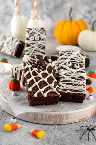 Cadılar Bayramı tatlısı. Çikolatalı kek, mumya şeklinde çikolatalı krema ve örümcek şeklinde ağ ile süslenmiş. Üst görünüm, alanı kopyala