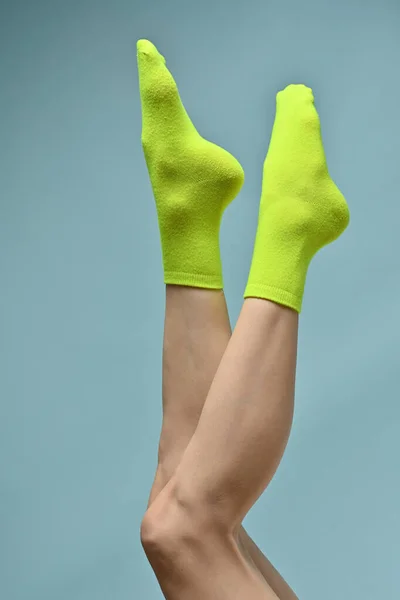 Woman with a green socks on her feet.