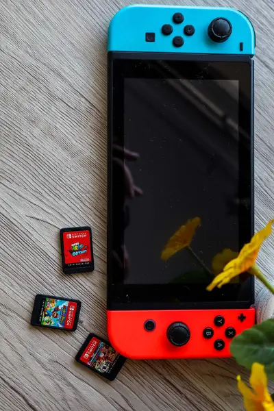 stock image Bandung, Indonesia - June 7th 2024 : A Nintendo Switch console displayed with both the screen turned on and off, accompanied by various gaming accessories