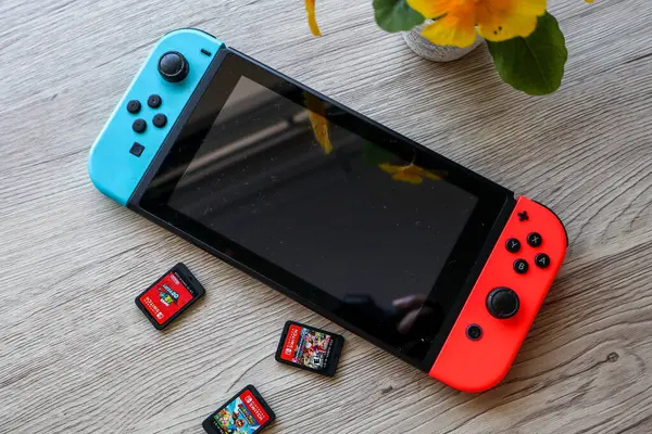 stock image Bandung, Indonesia - June 7th 2024 : A Nintendo Switch console displayed with both the screen turned on and off, accompanied by various gaming accessories