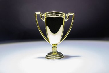 golden cup in white spotlight