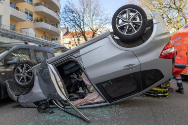 silver car is on the roof after an accident clipart