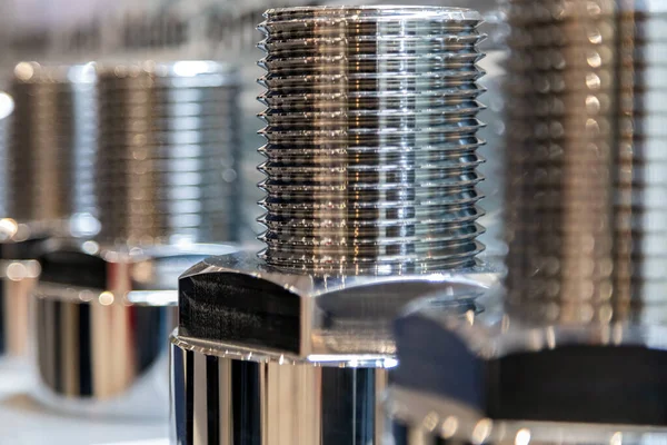 stock image large screws for wind turbines at a trade fair