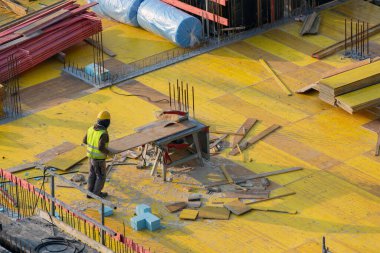 İnşaat işçisi, masa testeresi ile tavan resmi çalışması için tahtaları testereyle kesti