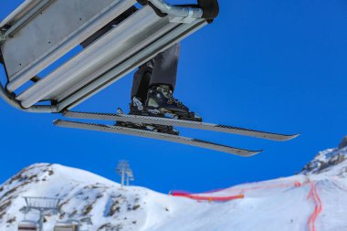 Skiers in the chairlift in Switzerland clipart