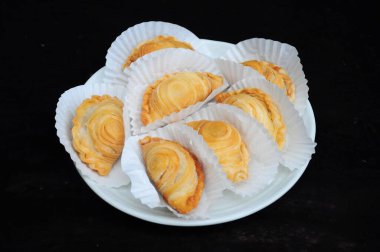 Chichen Curry Puffs on white plate