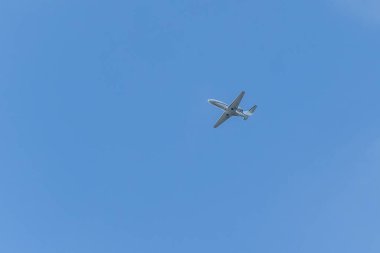 A private jet plane flying in a blue sky between clouds. Transportation. Air travel. Luxury.