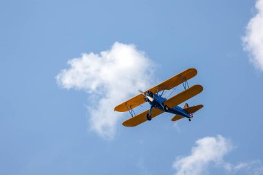 Klasik çift kanatlı uçak. Tek bir motor uçağı mavi gökyüzünü geçer. Ulaşım. Boş zaman. Koleksiyoncu. Klasik..