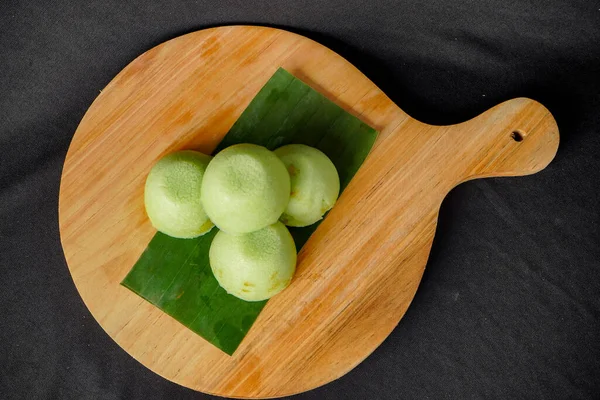 Stock image fresh green and yellow radish on wooden board