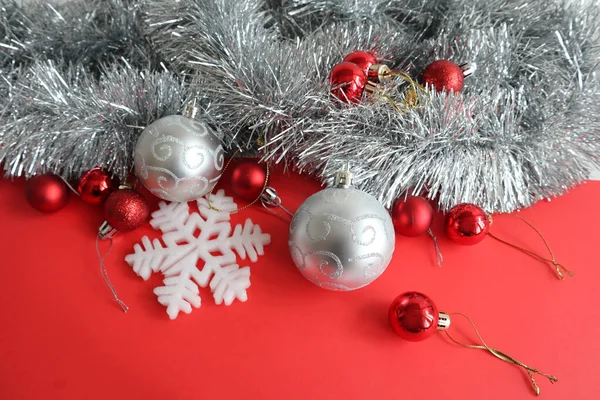 Christmas background with red and silver baubles on the red background
