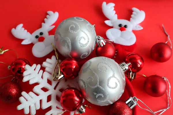 Christmas background with red and silver baubles on the red background