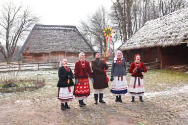 Singing Ukrainian carols for Christmas in skansen Pirogovo in Kyiv, Ukraine