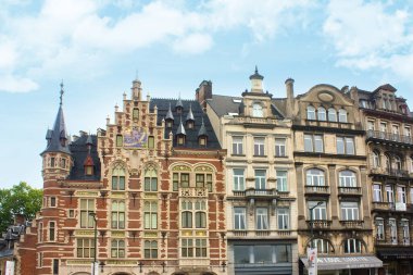 Pharmacie Anglaise in historic mansion with tower, product names in gold, red-white facade, bluish roof and sun dial on Koudenberg in central Brussels, Belgium