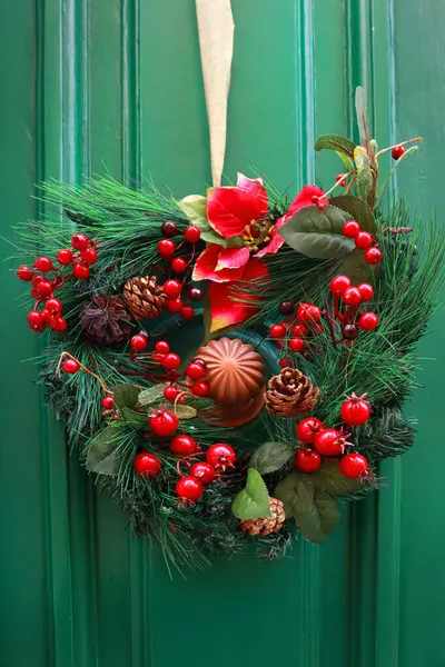Wooden green door with Christmas wreath in downtown of Mdina, Malta