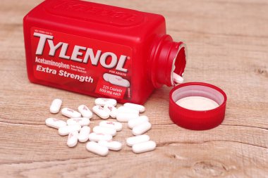 WASHINGTON, USA - October 15, 2022: Bottle Of Tylenol Extra Strength With Many Pills On A Wooden Table Which Was Sold Out During Covid-19 time, headache, Painkillers. clipart