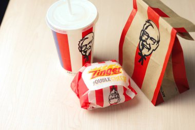 Bangkok, Thailand - January, 10 2023 : KFC Chicken Burger or Singer Burger served with soft drinks and french fries, KFC is a popular fast food in Thailand.
