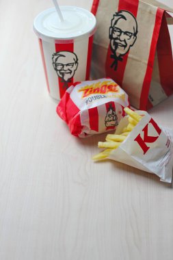 Bangkok, Thailand - January, 10 2023 : KFC Chicken Burger or Singer Burger served with soft drinks and french fries, KFC is a popular fast food in Thailand.