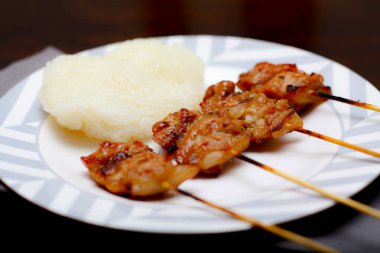 Yapışkan pirinçli domuz eti Tayland 'da kahvaltıda Tayland yemeği Tayland' da beyaz bir tabağa konur..